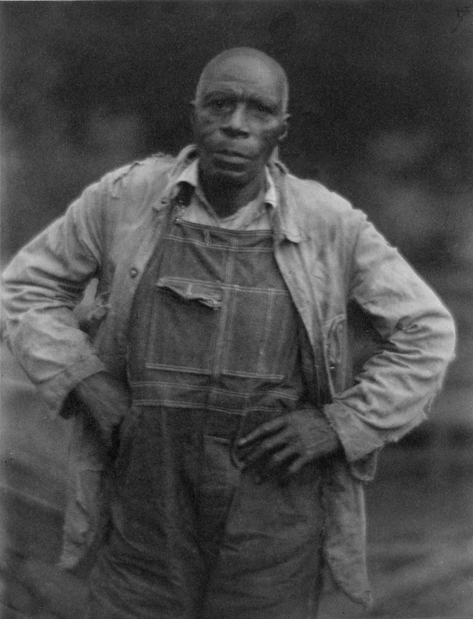 Man in overall door American Photographer