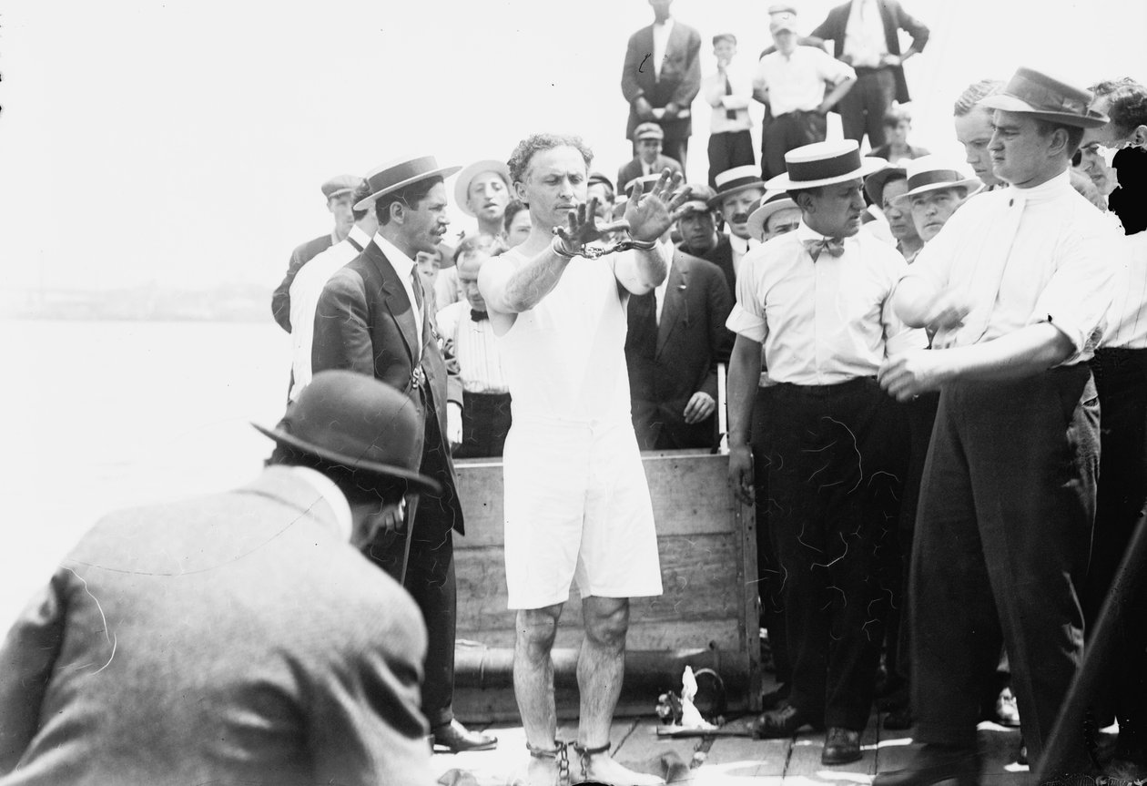 Harry Houdini wordt geboeid voordat hij in een kist wordt genageld en in de baai van New York wordt neergelaten, 1912 door George Grantham Bain