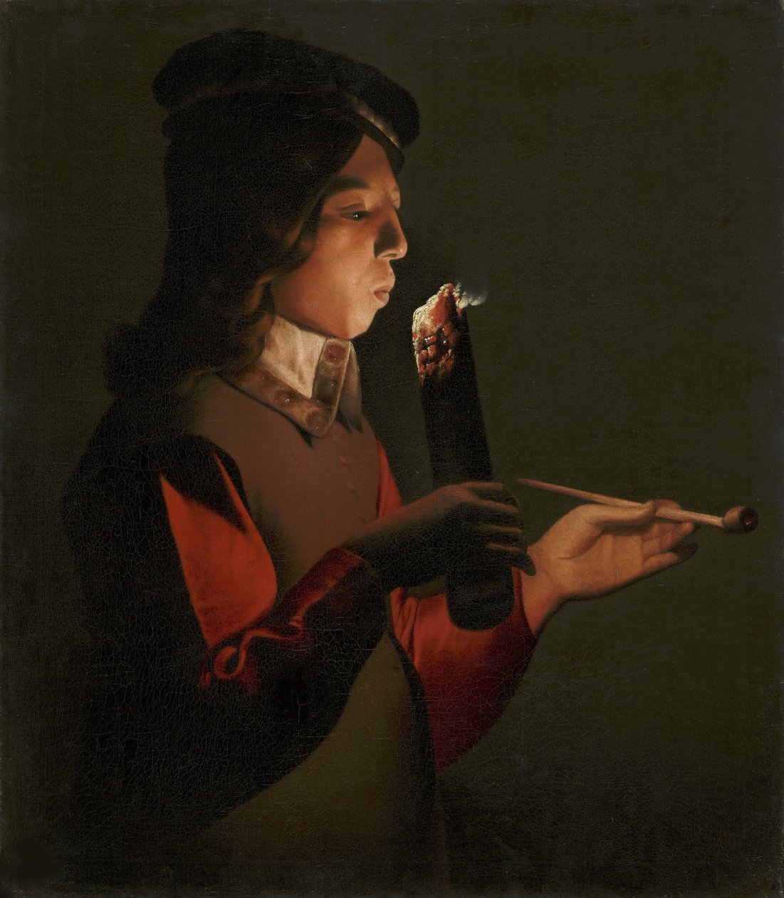 Een jonge jongen met een pijp, blazend op een brandende tak door Georges de La Tour