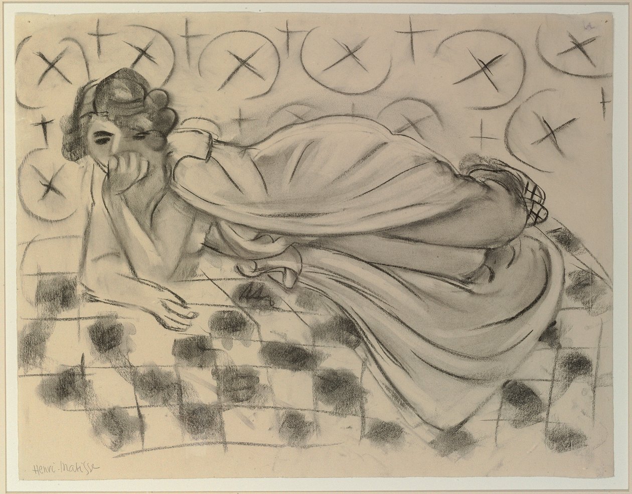 Gedrapeerde figuur liggend op een zwarte geruite sofa door Henri Matisse