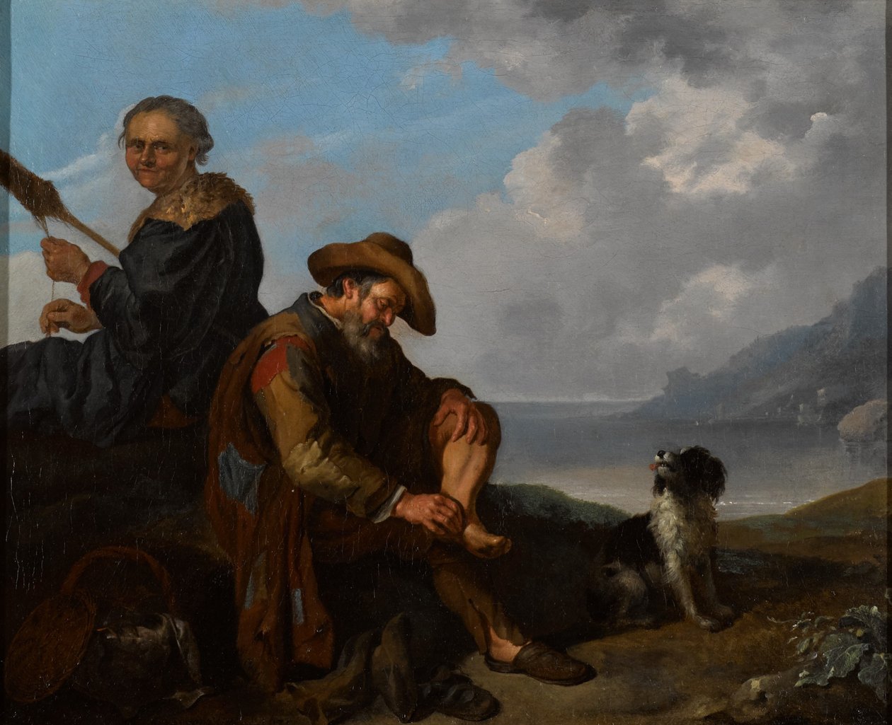 Een zuidelijk kustlandschap met een paar figuren en een hond door Jacob Toorenvliet
