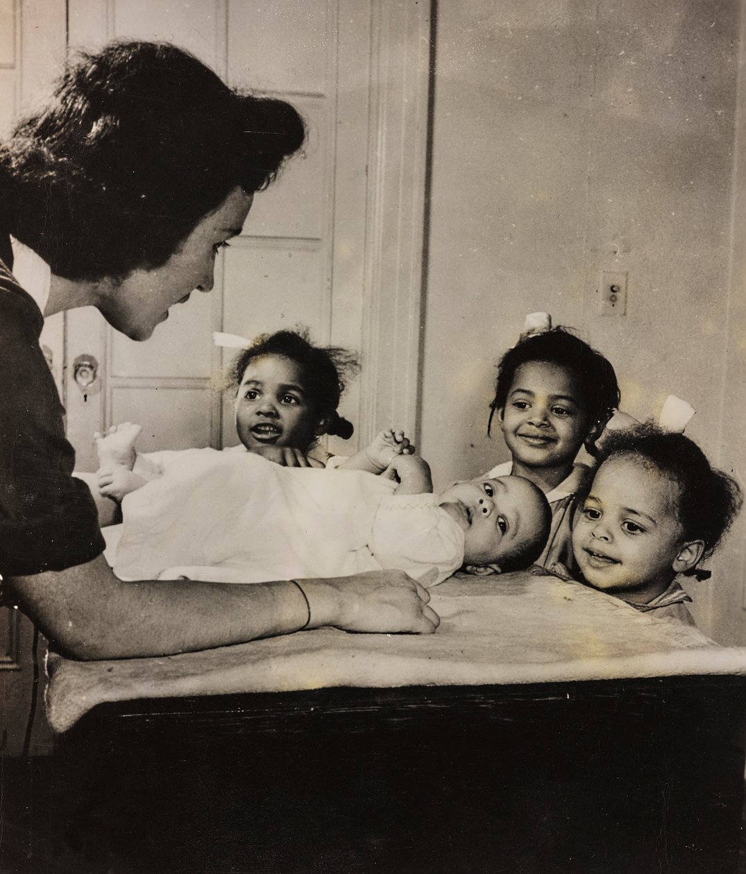 Verpleegster Henry Street helpt drie Afro-Amerikaanse meisjes in Harlem, New York City door Luigi Leoni