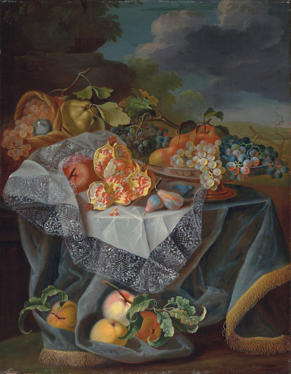 Druiven, peren en een appel op een glazen vaas, granaatappels en een geweven mand met fruit op een gedrapeerde tafel, en een parklandschap daarachter door Maximilian Pfeiler or Pfeiller