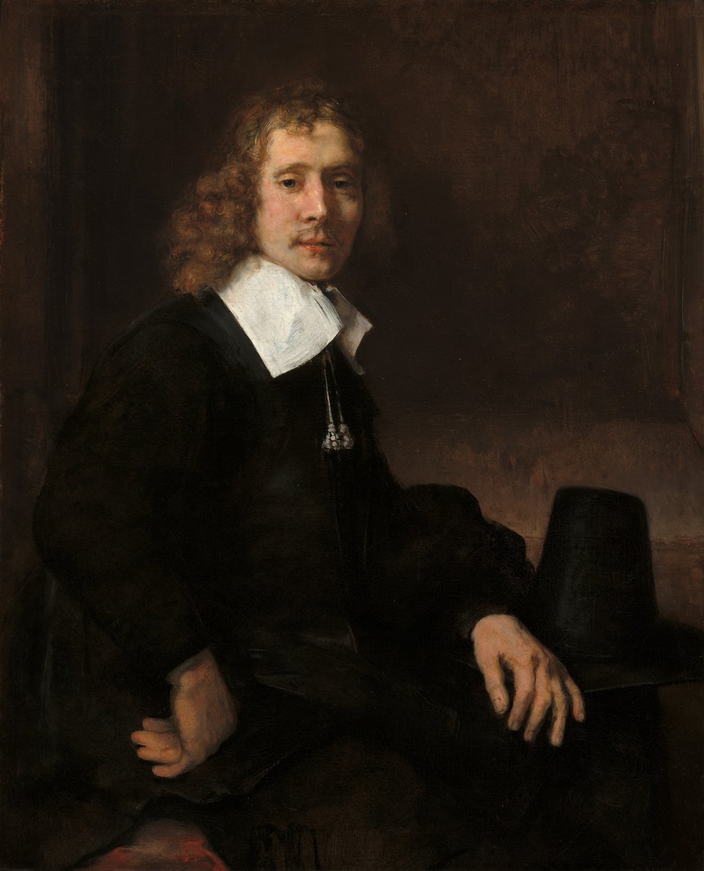 Een Jonge Man Zittend aan een Tafel (mogelijk Govaert Flinck) door Rembrandt van Rijn