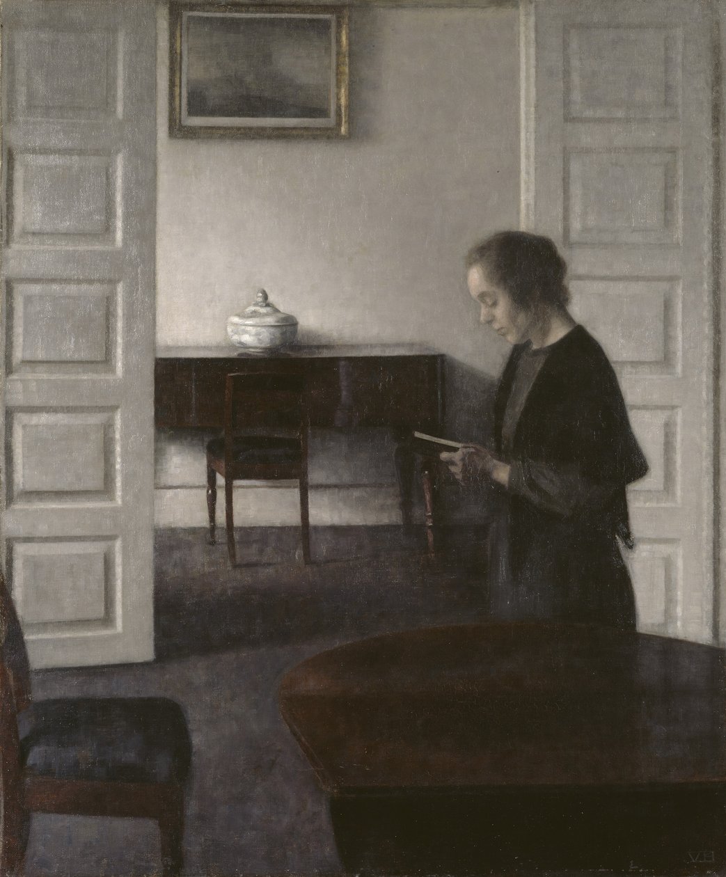 Interieur met een lezende dame door Vilhelm Hammershoi