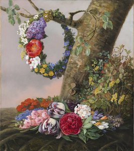 Een boeket bloemen aan de voet van een boom. Aan een tak hangt een bloemenkrans