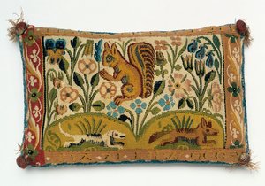 Een speldenkussen tapijt paneel met een eekhoorn en motto 