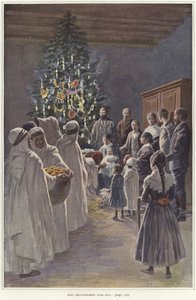 Een familie kijkt naar een kerststal bij een kerstboom