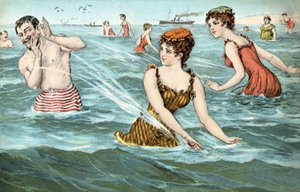 Meisjes spetteren een man in de zee nat