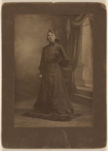 [Portret van een jonge vrouw in lange zwarte jurk, staand]. door George W. Killian