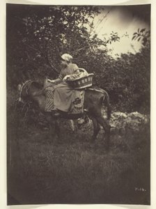 Vrouwelijke boer rijdt ezel