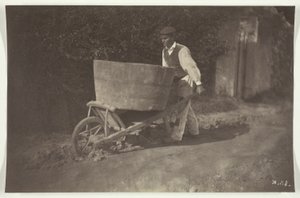 Mannelijke boer met kruiwagen