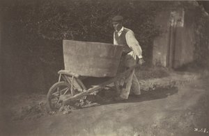 Mannelijke boer met kruiwagen