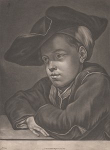 Jongen zittend aan een tafel