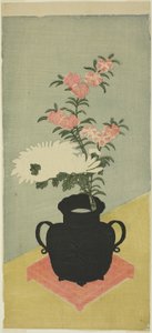 Witte chrysanten en anjers in een zwarte vaas