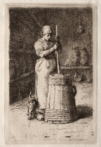 Een vrouw die boter karnet