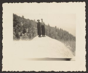 [Figures Standing on Rock].