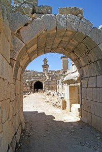 Uitzicht door de gewelfde ingang van het Xanthos-theater naar de orkestbak, met zuil en Harpy-tombe, Xanthos, Turkije door Roman