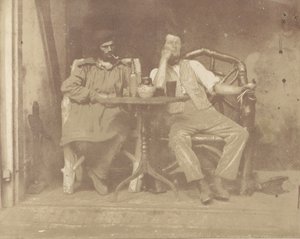 Twee mannen zittend aan een tafel door Unbekannt