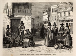 Een straat in Wales, met lokale bewoners gekleed in traditionele kostuums, en dagelijkse activiteiten: een gezin en vrouwen die wol spinnen met wielen. Gravure ter illustratie van een reis naar Wales, in 1862, door Alfred Erny, in 