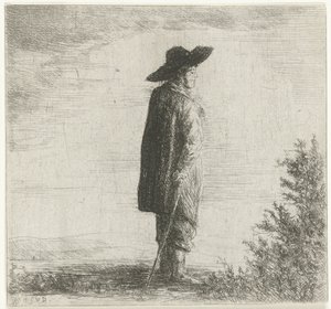 Man met hoed en stok in landschap