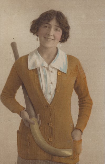 Mooi meisje, in gebreide trui, met pareloorbellen, met hockeystick door English Photographer