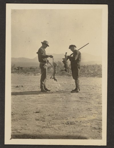 [Fleckenstein and Man Holding Guns and Dead Jackrabbits]. door Louis Fleckenstein