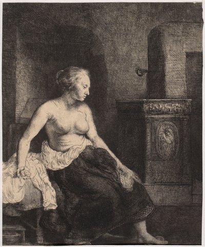 Een halfnaakte vrouw die bij de kachel zit door Rembrandt van Rijn