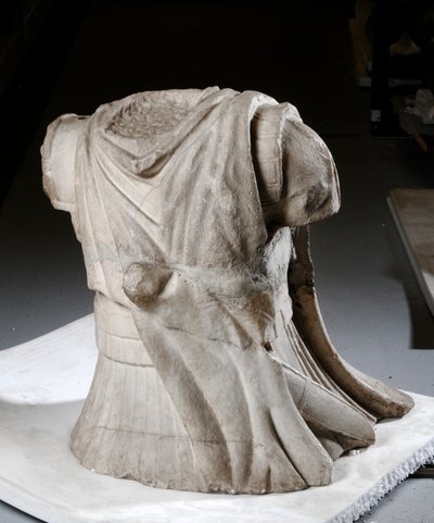Gebeeldhouwd torso van een ruiter met zwaar versleten mantel door Roman Roman