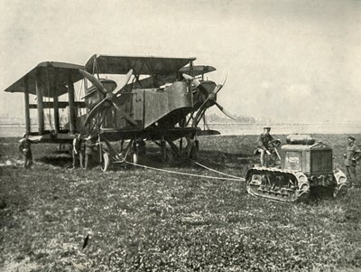 Een kleine motortractor die een enorme R.A.F. bommenwerper op zijn plaats zet..., 1919 door Unbekannt