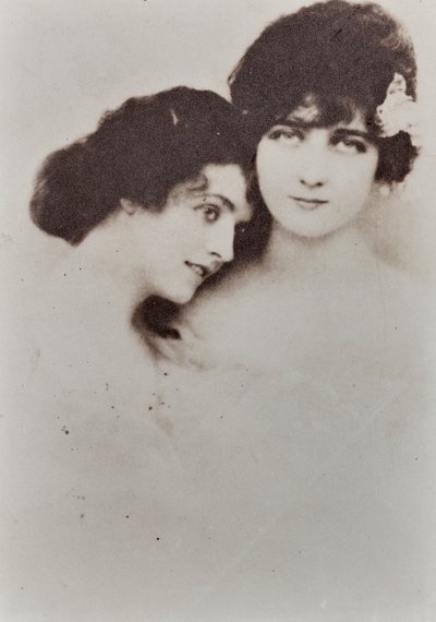 Halflang portret van twee jonge vrouwen in een tedere pose door Unknown photographer