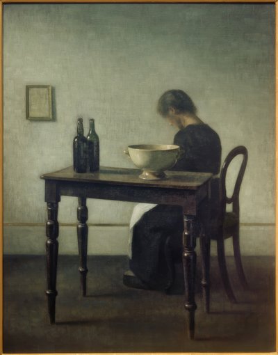 Vrouw, zittend achter een tafel door Vilhelm Hammershoi