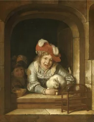 Twee kinderen spelen met een kat met een vogel in zijn klauwen