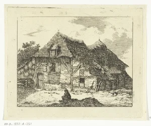 Man zittend op een heuveltje voor een huis te Staphorst