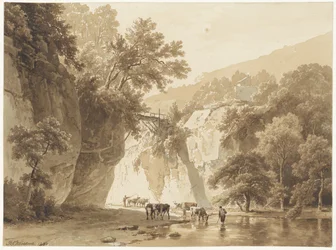 Rotsachtig landschap met drinkende koeien