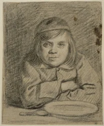Jongen met gevouwen armen aan een tafel