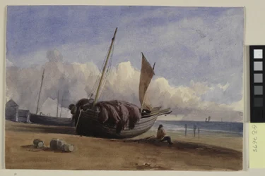 Gestrand vissersboot met zittende visser