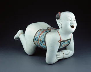 Een Chinees porseleinen kussen in de vorm van een halfnaakte jongen