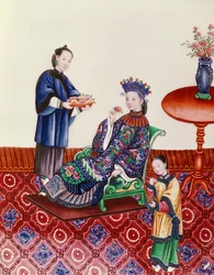 Elegante Chinese dame die aan een bloem ruikt