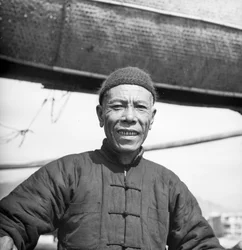 Een portret van een van de bemanningsleden van een Canton zoutschuit aan boord van zijn schip in Sham Shui Po, Hong Kong