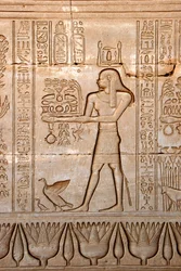 Egyptische oudheid: voorstelling van een man die offers brengt aan de godin, Tempel van Hathor, Denderah, Egypte - Egyptische beschaving: een man die offers brengt aan de godin Hathor, uitgehouwen op de muur van de Hathor-tempel (of Tempel van Tentyra) in 