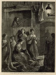 Londens leven in het Oostelijke Einde - zakken maken bij het licht van een straatlantaarn