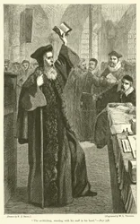 De aartsbisschop, staande met zijn staf in zijn hand