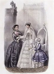 Een vrouw in een trouwjurk omringd door een meisje en een dame - in 