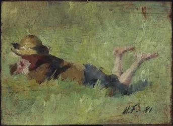 Jongen liggend in gras