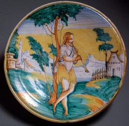 Renaissancekunst: schaal versierd met een fluitspeler (Een fluitspeler) - Eind 16e eeuw. Vervaardigd in Viterbo (Viterbo), Italië. Florence, Museo Nazionale del Bargello