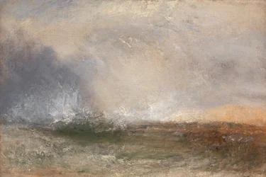 Stormachtige zee die op een kust breekt