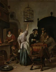 Interieur met een vrouw die een papegaai voedt, bekend als 