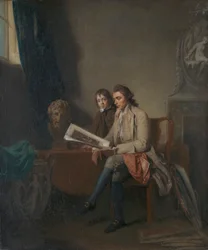 Portret van een man en een jongen die naar prenten kijken