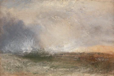 Stormachtige zee die op een kust breekt
